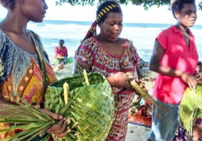 Women carry recently made handicrafts