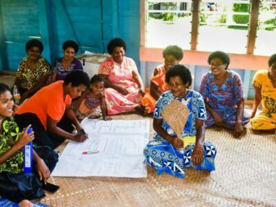 A group of women drawing a map