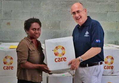 Woman and man with hygiene kit for Cyclone Harold response