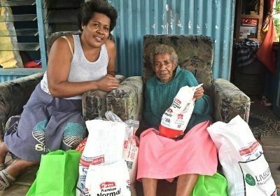 A family receives ration packages from Live & Learn Fiji 