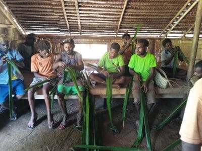 Young men practicing traditional skills