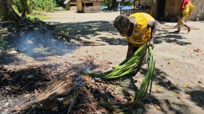 A woman lighting a fire