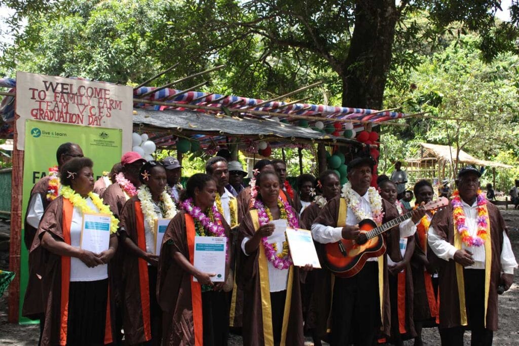 A group of people standing with education certificates at their graduation ceremony