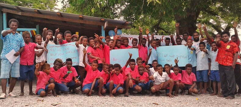 Boy students holding messages of support for girls